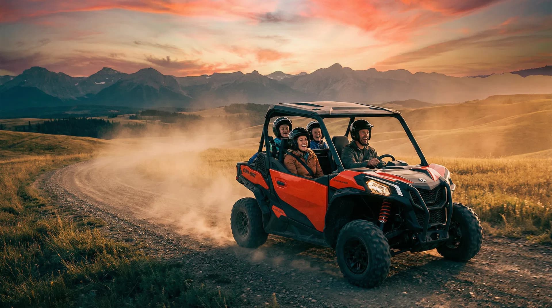 Family riding side-by-side UTV in Alberta foothills